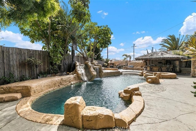 view of swimming pool with a patio and pool water feature