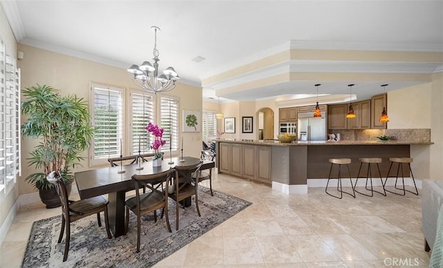 dining room featuring an inviting chandelier, baseboards, arched walkways, and crown molding