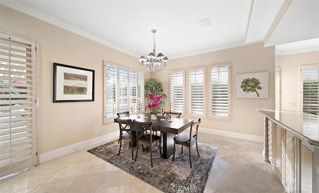 dining room with baseboards, a chandelier, and crown molding