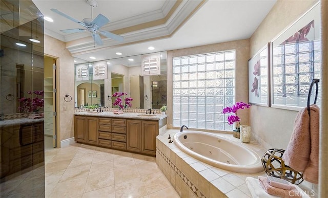 bathroom with crown molding, double vanity, a sink, ceiling fan, and a whirlpool tub