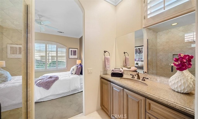 ensuite bathroom with ensuite bathroom, ceiling fan, and crown molding