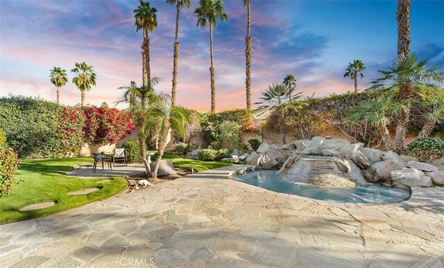 3 Mesquite Ridge Ln, Rancho Mirage, CA 92270 - pool at dusk with a patio and a lawn