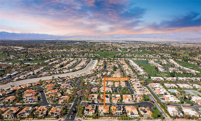 aerial view at dusk featuring a mountain view