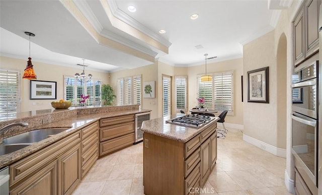 kitchen featuring beverage cooler, appliances with stainless steel finishes, light stone counters, crown molding, and a sink