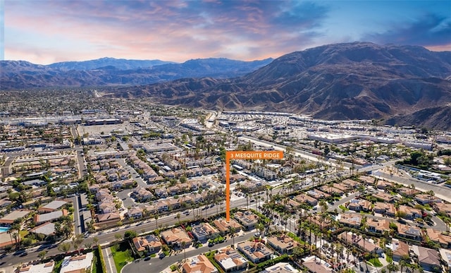 aerial view at dusk featuring a mountain view