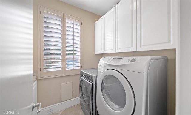 clothes washing area with cabinet space and separate washer and dryer