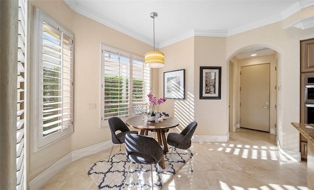 dining area featuring ornamental molding, arched walkways, and baseboards