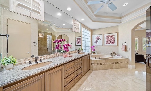 full bathroom featuring a bath, crown molding, a sink, and a shower stall