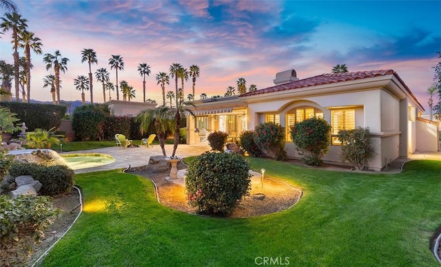 3 Mesquite Ridge Ln, Rancho Mirage, CA 92270 - rear view of house featuring a lawn, a patio area, and a tile roof