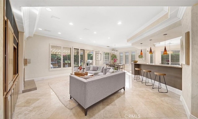 living area featuring baseboards, ornamental molding, recessed lighting, and a healthy amount of sunlight