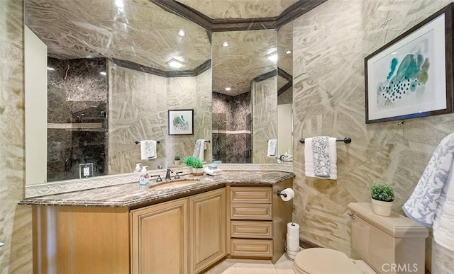 full bathroom with vanity, tile walls, toilet, and walk in shower