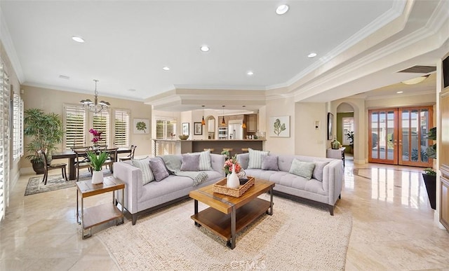 living area with french doors, crown molding, recessed lighting, visible vents, and an inviting chandelier