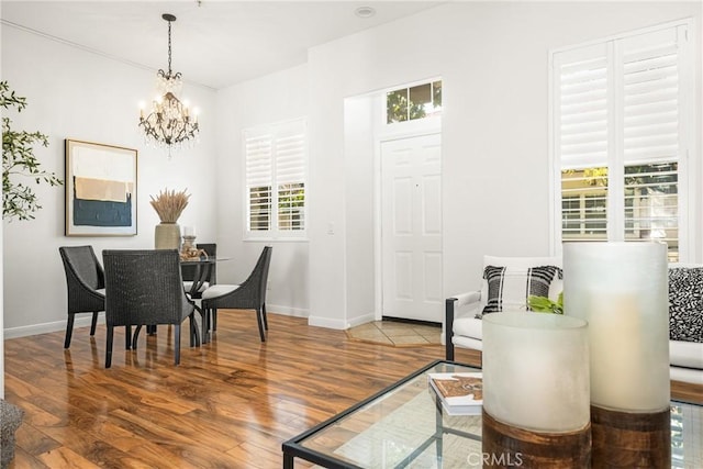 dining area featuring hardwood / wood-style floors and a notable chandelier