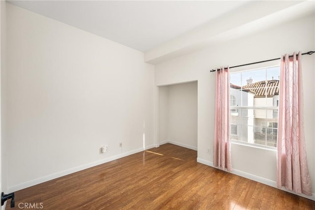 unfurnished room with hardwood / wood-style floors