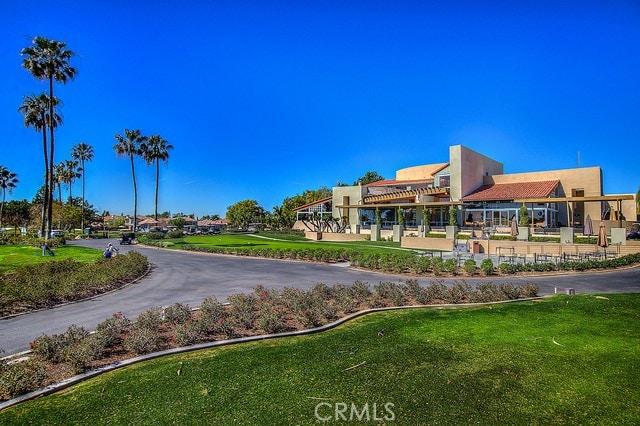 view of property's community with a pergola and a lawn