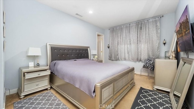 bedroom with light colored carpet, visible vents, baseboards, and recessed lighting