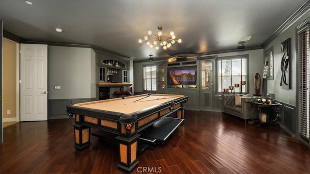 rec room with crown molding, a dry bar, pool table, dark wood-type flooring, and wainscoting