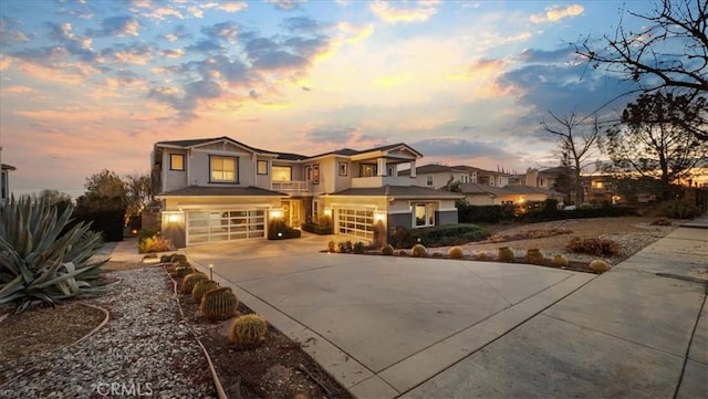 view of front of house featuring a garage, a residential view, and driveway