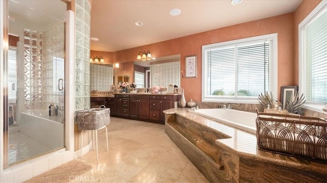 bathroom featuring recessed lighting, vanity, a bath, tile patterned floors, and a stall shower