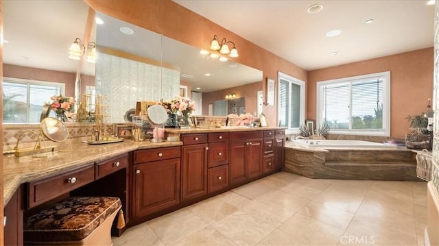 full bath with tile patterned flooring, a garden tub, and vanity