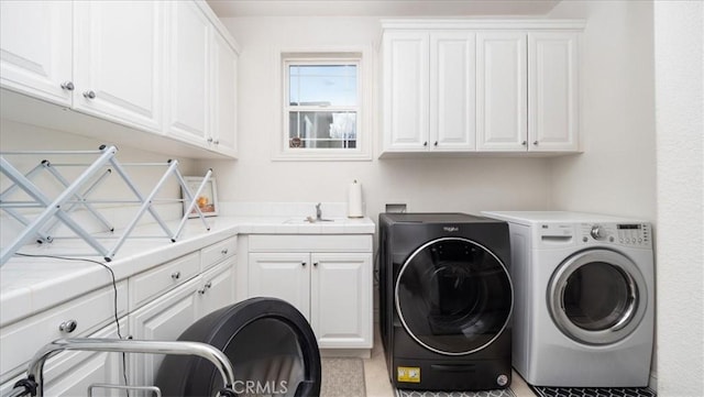 laundry room featuring a sink, washing machine and clothes dryer, and cabinet space