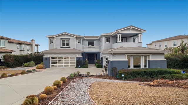 view of front facade featuring an attached garage, a balcony, brick siding, concrete driveway, and a residential view