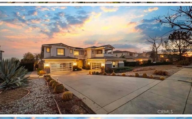 view of front facade with a garage, a residential view, and driveway