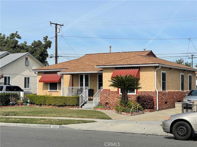 bungalow-style house with a front yard and a porch