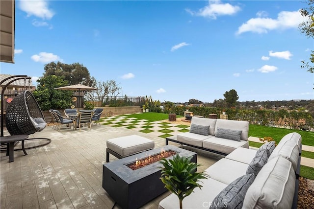 view of patio / terrace featuring an outdoor living space with a fire pit and outdoor dining space