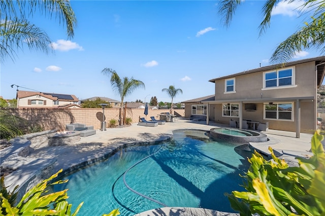 view of swimming pool with an outdoor fire pit, a patio area, a fenced backyard, and a pool with connected hot tub