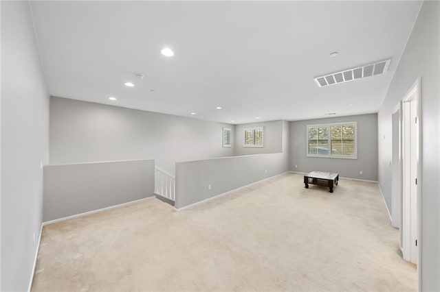 recreation room with light colored carpet, visible vents, baseboards, and recessed lighting