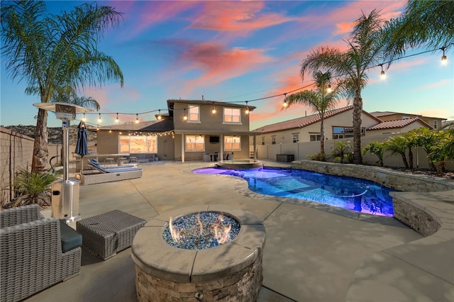 view of swimming pool with a patio, central AC unit, a fenced backyard, an in ground hot tub, and a fenced in pool