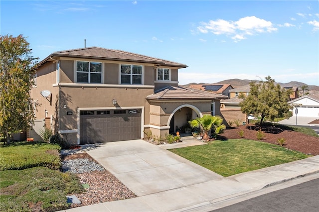 view of front of property with an attached garage, a mountain view, a tile roof, concrete driveway, and stucco siding