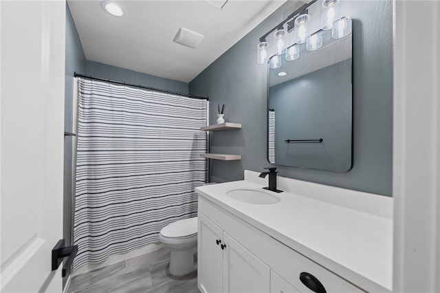 full bathroom featuring curtained shower, vanity, and toilet