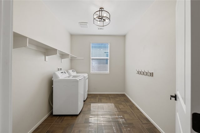 laundry area featuring laundry area, visible vents, baseboards, and separate washer and dryer