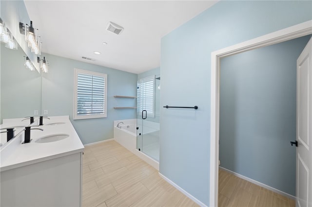 bathroom with double vanity, a garden tub, visible vents, and a sink