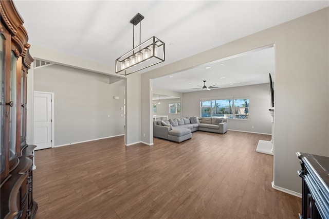 unfurnished living room featuring a ceiling fan, recessed lighting, dark wood-style flooring, and baseboards