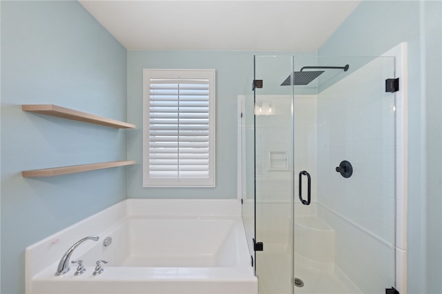 bathroom with a stall shower and a bath