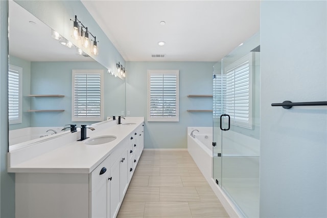 bathroom featuring a garden tub, a sink, visible vents, double vanity, and a stall shower