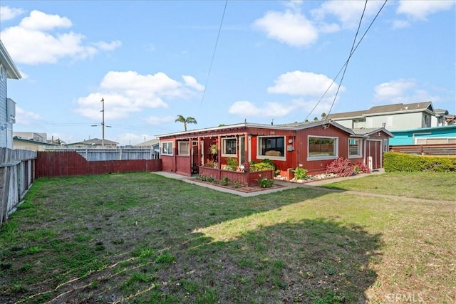 back of property featuring a lawn