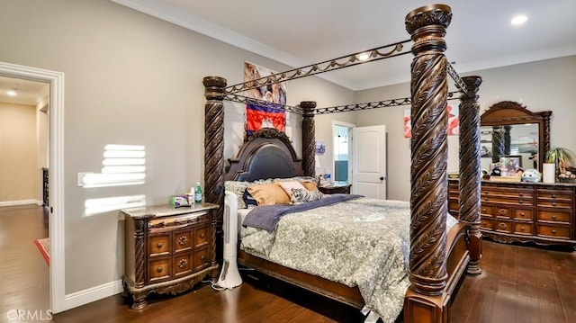 bedroom with ornamental molding and dark hardwood / wood-style floors