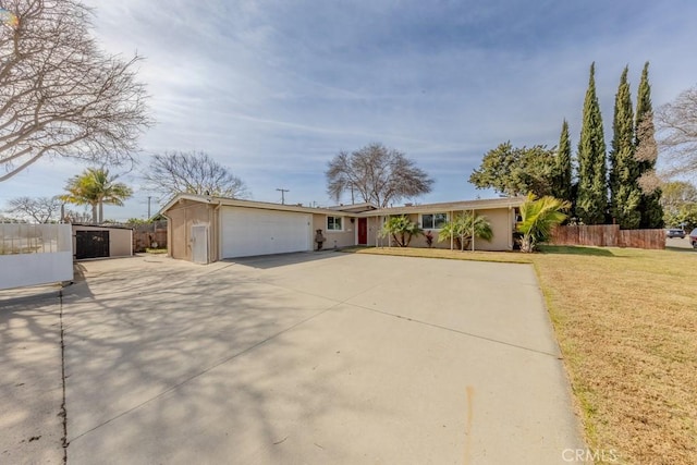 ranch-style house featuring a garage and a front lawn