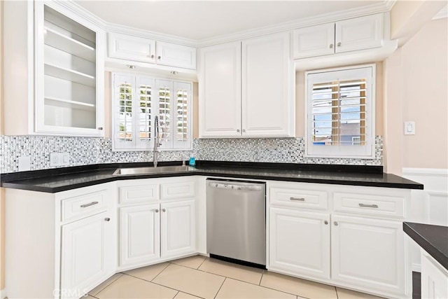 kitchen with backsplash, dishwasher, sink, and white cabinets