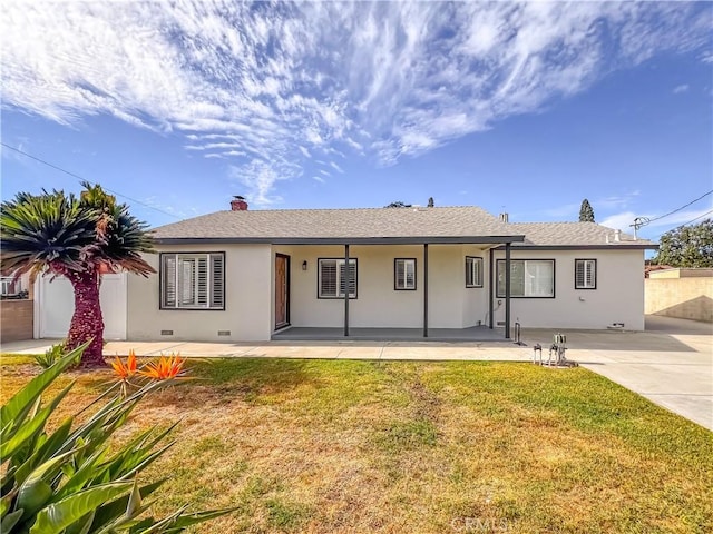 view of front of house with a patio area and a front lawn