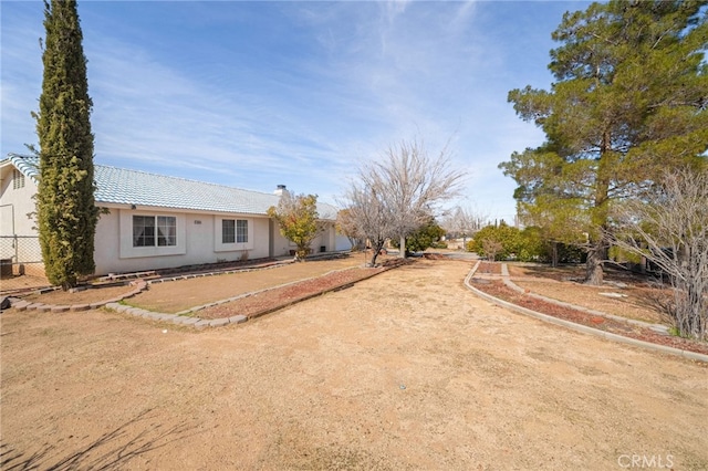 view of yard with fence and driveway