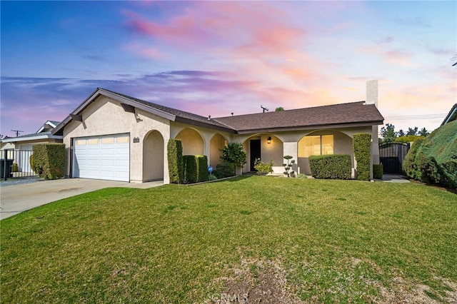 ranch-style home with a yard and a garage