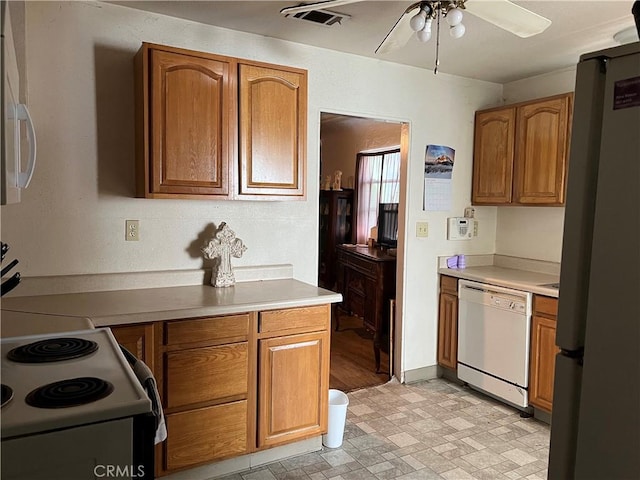 kitchen with range with electric stovetop, ceiling fan, stainless steel refrigerator, and white dishwasher