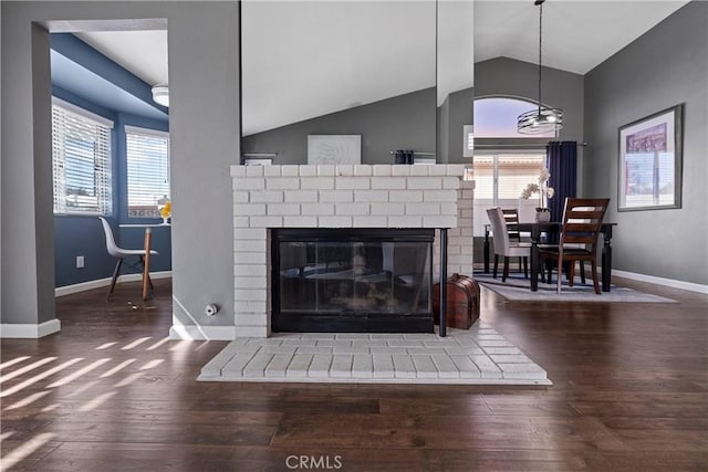 interior details featuring a fireplace, wood finished floors, and baseboards