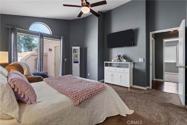 bedroom featuring a ceiling fan, dark carpet, and baseboards