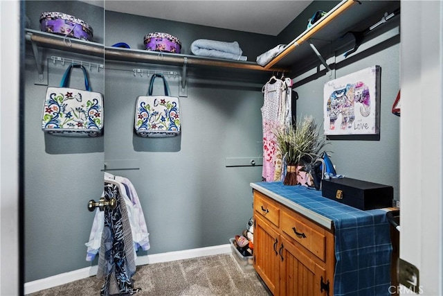 walk in closet with carpet